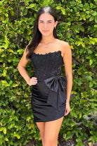 KissProm Strapless Appliques Ruched Homecoming Dress with Bow | This dress is designed in a chic sheath silhouette that hugs your curves beautifully while offering a comfortable fit.