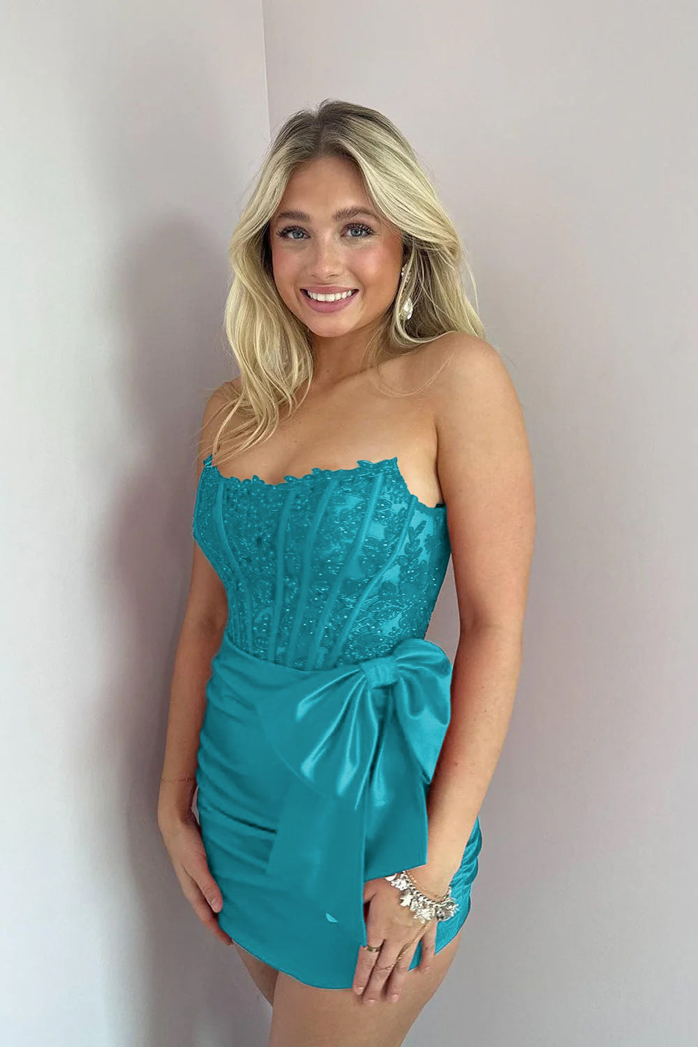 KissProm Strapless Appliques Ruched Homecoming Dress with Bow | This dress is designed in a chic sheath silhouette that hugs your curves beautifully while offering a comfortable fit.