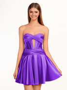 KissProm A-line Strapless Fuchsia Pleated Homecoming Dress with Keyhole | The pleated design adds an elegant touch, while the keyhole detail at the neckline provides a modern twist. The lace-up back ensures a secure fit.