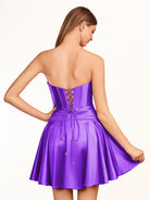 KissProm A-line Strapless Fuchsia Pleated Homecoming Dress with Keyhole | The pleated design adds an elegant touch, while the keyhole detail at the neckline provides a modern twist. The lace-up back ensures a secure fit.