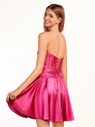 KissProm A-line Strapless Fuchsia Pleated Homecoming Dress with Keyhole | The pleated design adds an elegant touch, while the keyhole detail at the neckline provides a modern twist. The lace-up back ensures a secure fit.