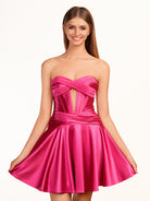 KissProm A-line Strapless Fuchsia Pleated Homecoming Dress with Keyhole | The pleated design adds an elegant touch, while the keyhole detail at the neckline provides a modern twist. The lace-up back ensures a secure fit.